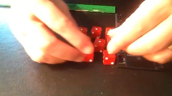Red dice being adjusted into starting configuration